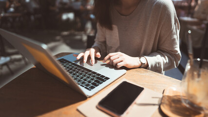 Business freelancer adult asian woman working with laptop computer at cafe.