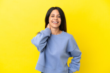 Young caucasian woman isolated on yellow background laughing