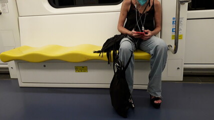 thin woman sitting in the subway