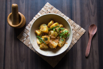 View from top of aloo jeera or potato saute with cumin and coriander. Aloo jeera is served with roti, puri or chapati as snacks or meal menu. 