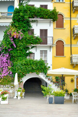 Beautiful yellow house with pink nerium in Rida del Garda, Italy