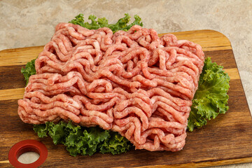 Raw pork minced meat over board