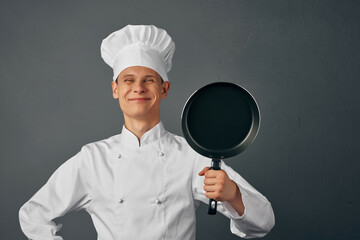 man chef surprised expression frying pan in hands restaurant