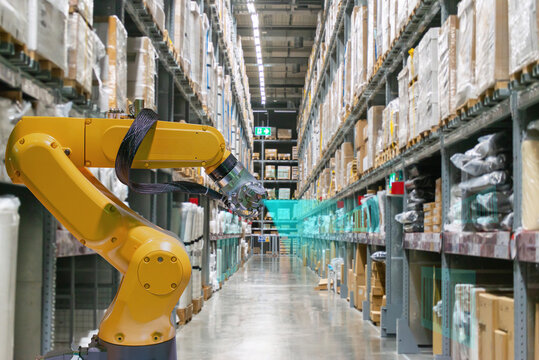 An industrial robotic arm is scanning product barcodes in a warehouse.