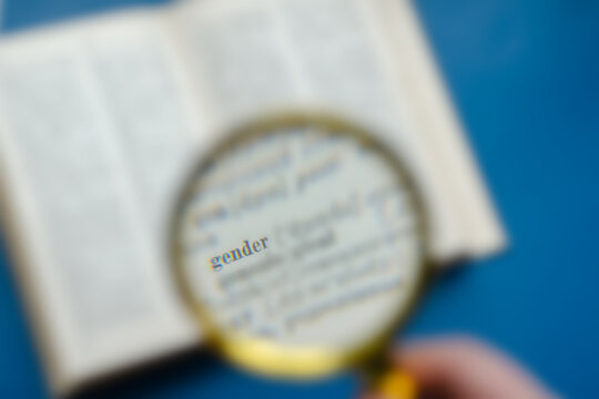Defocus, blur, noise effect. Word Gender focuses on a magnifying