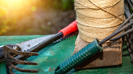 Set of garden tools on a garden background. Concept of gardening or planting. I work in the spring...