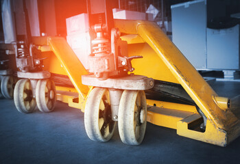 Close up, Hand Pallet Truck in The Warehouse.  Work Tools for Unloading in The Warehouse.
