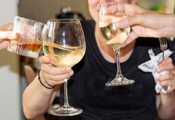 Hands holding drink glasses, party time