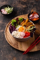 Korean Bibimbap. Bowl with meat, rice and salad
