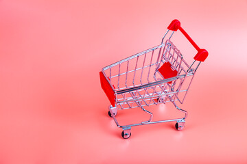 Shopping cart on a pink background.