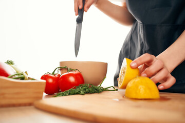 slicing lemon on a cutting board kitchen vegetables cooking