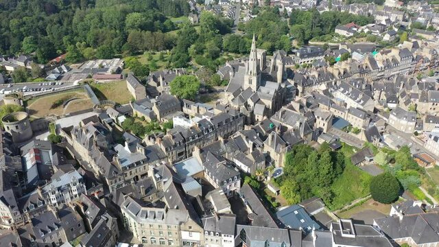 General view of French town of Guingamp in summer looking out over medieval Basilica and walls of ancient fortified chateau, Brittany