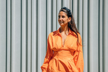 young woman in orange dress outdoors