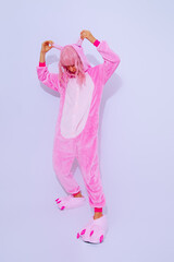 Pink Pajamas Party Girl posing in white studio.  Home Relax style. Kigurumi shop concept
