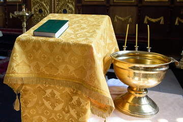 A font for the baptism of a child in a church. The ceremony of the Christian religion.