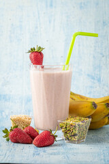 Strawberry and banana cold smoothie on blue background