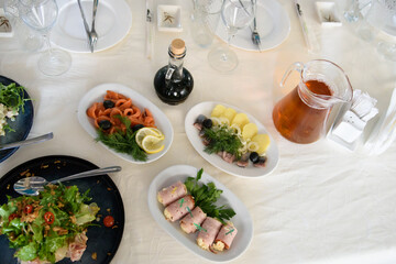 A table with dishes of food for the reception of guests. Festive eating at a banquet party.