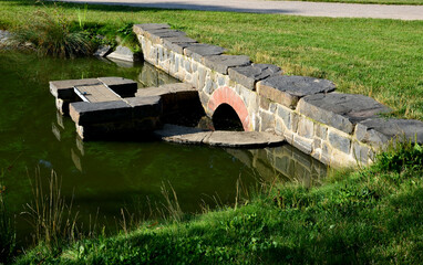 Clogged water bridges and canals made of arched bricks. water through the branches and various...