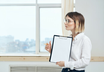 Business woman in white shirt documents office