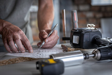 A carpenter works with professional woodworking tools.