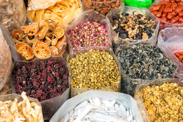 Heaps of tea, dried herbs and grocery at traditional chinese street market in asian town. Bangkok, Thailand