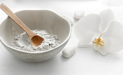 Spa composition with powder face mask and orchid flower.