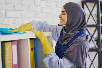 Arabian woman enjoys making an office clean