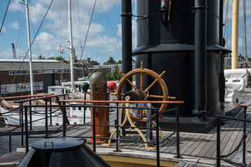 Den Helder, the Netherlands. August 2021. Rudder and compass of an old warship in the harbor of Den Helder.