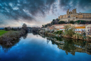 Fototapeta na wymiar The River Orb at Beziers, overlooked by the St. Nazaire Cathedral, seen at dusk