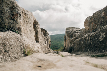 Fototapeta na wymiar Main road between caves in ancient stone town-fortess Eski-Kermen. Bakhchysarai, Crimea.