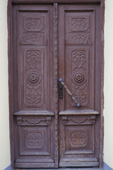 Old classic wooden doors with carved patterns.