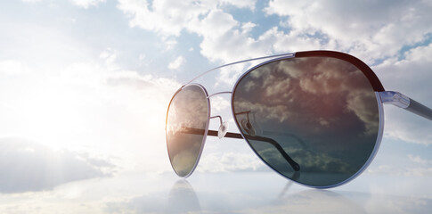 Polarized sunglasses on sunny sky UV protection
