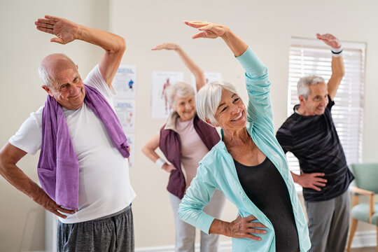 Senior people stretching at gym