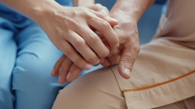 Close-up Young Asian woman nurse caregiver assistance encourage take care her senior patient hold hand explain with positive keep comforting in hospital ward, Hospital environment concept.