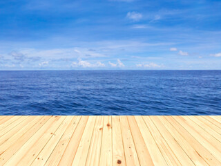 Fototapeta premium Wooden floor or plank on sand beach in summer. For product display.Calm Sea and Blue Sky Background.