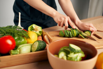 Obraz na płótnie Canvas cutting fresh vegetables on a cutting board kitchen healthy eating at home
