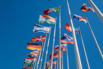 Different flags fluttering on flagpoles