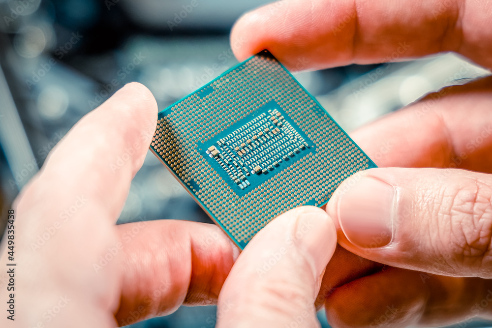 Poster pc central processor chip in the hands of a technician. selected focus, close-up. pc assembly and up