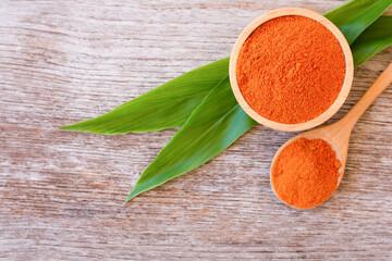 Tumeric (Curcumin, Curcuma longa Linn) powder in wooden bowl 