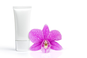 Purple Cymbidium orchid flower and moisturizer skin care face cream in plastic tube isolated on white background.