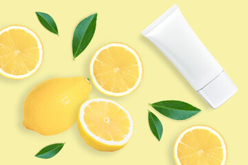 Lemon skin care cream lotion in plastic tube isolated on yellow background. 
