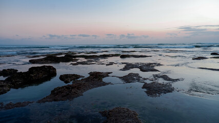 Sea waves lash line impact rock on the beach