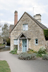 Fototapeta na wymiar A cottage by the Old Mill in Lower Slaughter in Gloucestershire in the UK