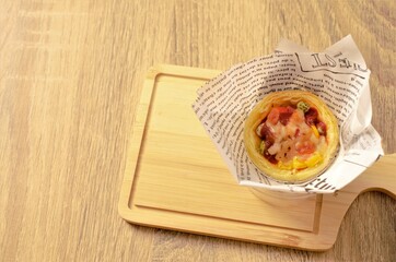 Egg tart pizza on wooden plate backgrounds