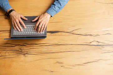 Male hands typing on the keyboard, journalist is writing the article, man chatting online, texting in social networks, sending emails, top view, copy space, bunner