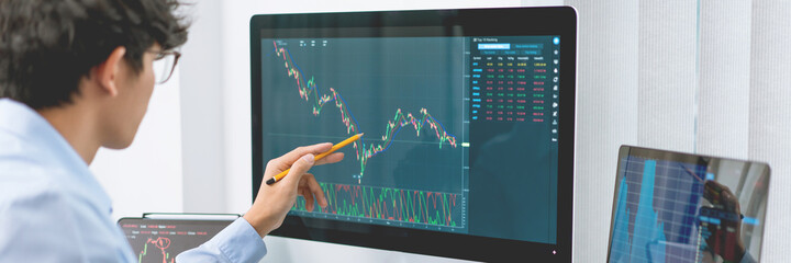 Financial concept a businessman studying the stock chart analyzing the growths of the stock from...