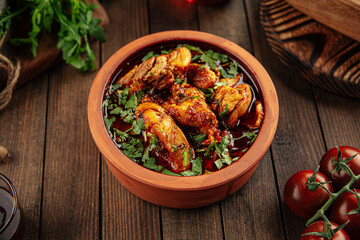 Georgian dish chakhokhbili stewed chicken in a clay bowl