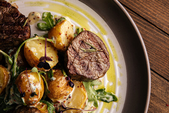 Closeup on a plate of gourmet fillet mignon steaks with potatoes 