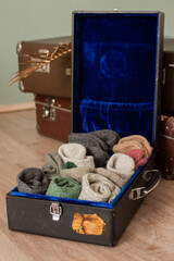 Many knitted woolen socks lying in old suitcases