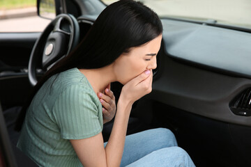 Fototapeta na wymiar Young woman suffering from nausea in car